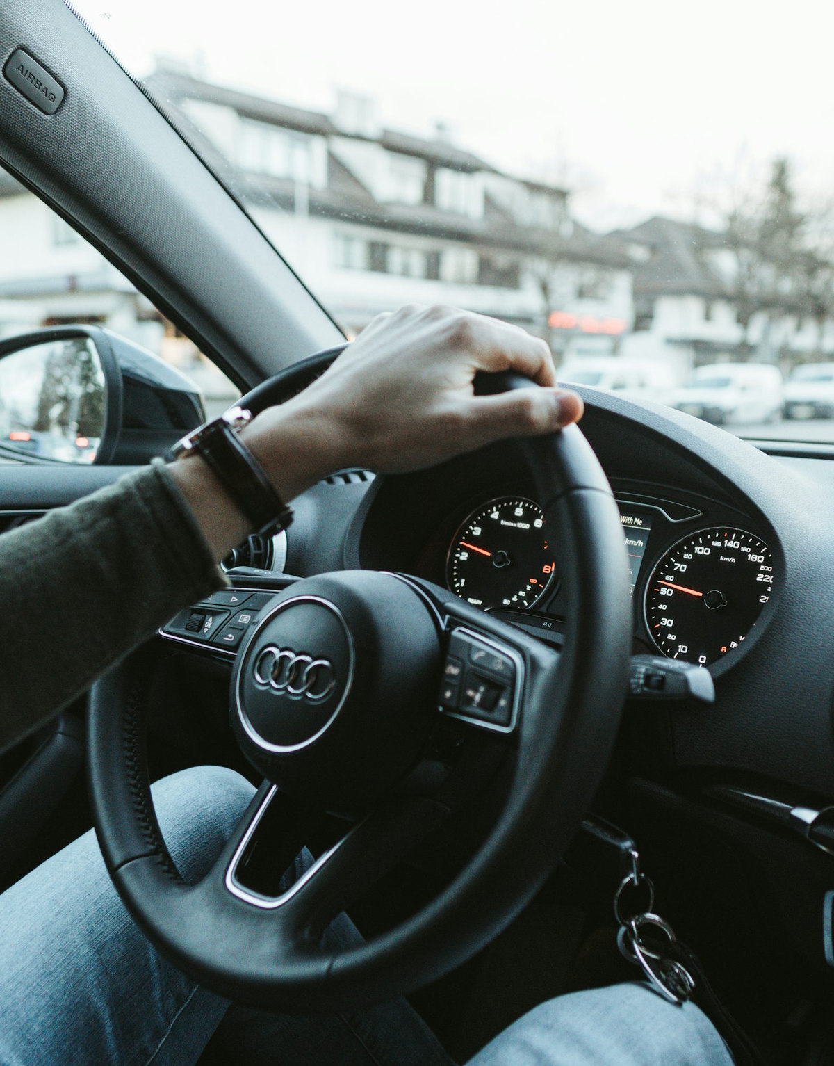 Hands on the wheel, city ahead
